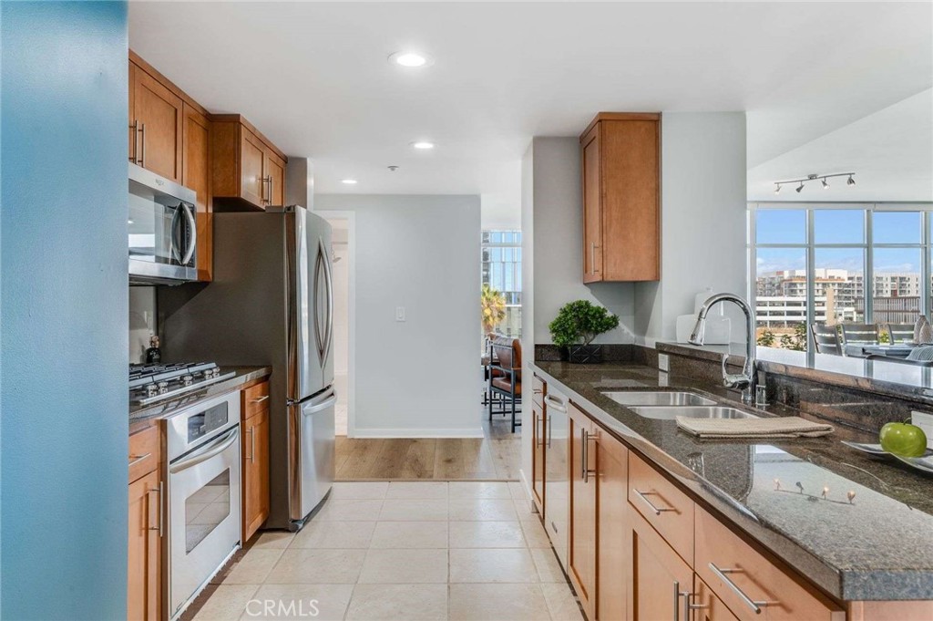 400 West Ocean Boulevard, Unit 206 Long Beach, CA 90802 - Photo 11 of 48 a kitchen with stainless steel appliances granite countertop a sink stove and refrigerator