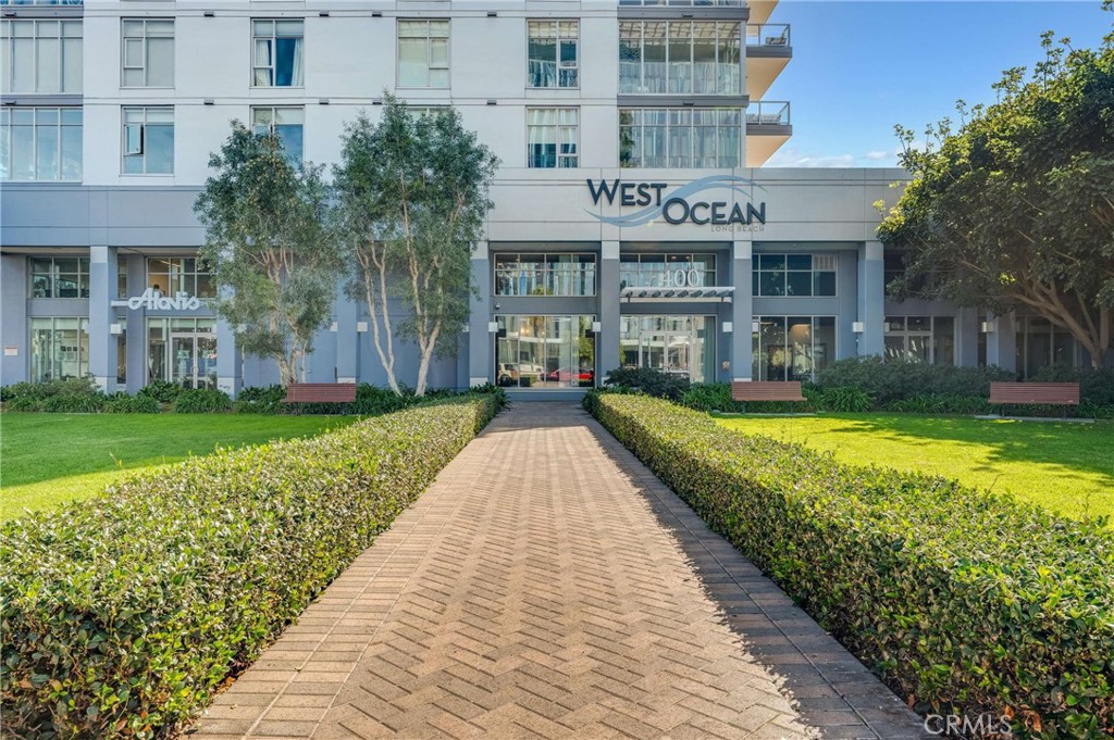 400 West Ocean Boulevard, Unit 206 Long Beach, CA 90802 - Photo 2 of 48 a front view of a building with a garden and plants