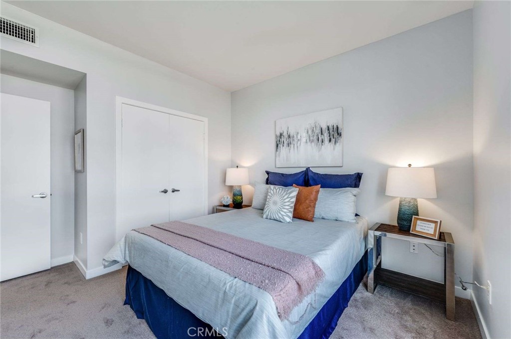 400 West Ocean Boulevard, Unit 206 Long Beach, CA 90802 - Photo 22 of 48 a bedroom with a bed and a night stand