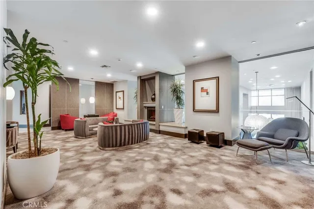 a living room with furniture and a potted plant