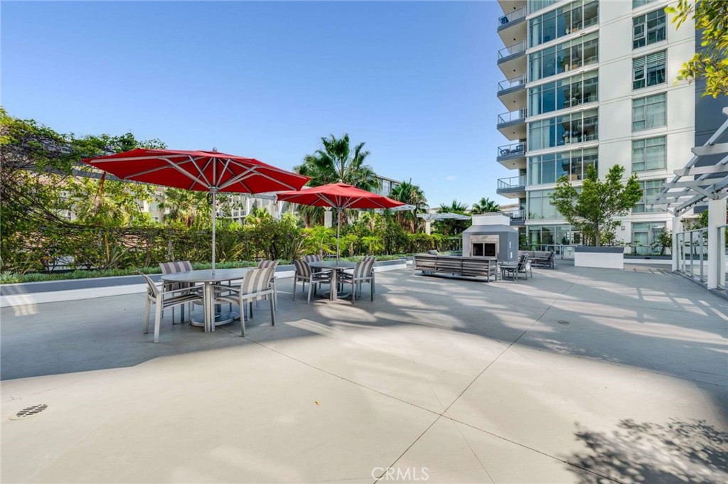 400 West Ocean Boulevard, Unit 206 Long Beach, CA 90802 - Photo 37 of 48 a view of a patio with a table and chairs under an umbrella