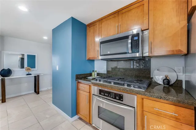 a kitchen with a stove microwave and sink