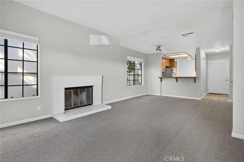 2720 Gramercy Avenue, Unit 5 Torrance, CA 90501 - Photo 11 of 35 an empty room with windows and fireplace