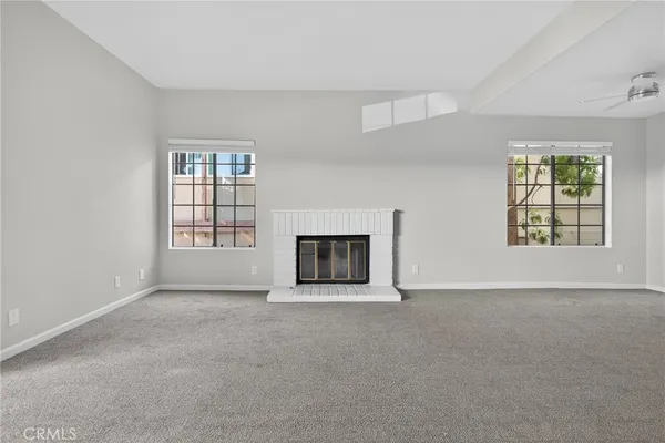 a view of empty room with a fireplace