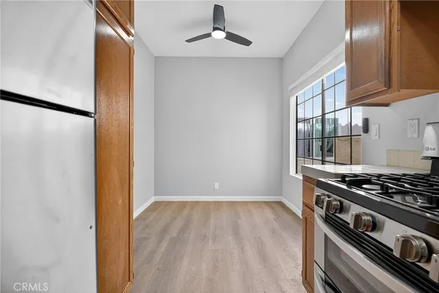a kitchen with stainless steel appliances granite countertop a stove a sink and a refrigerator