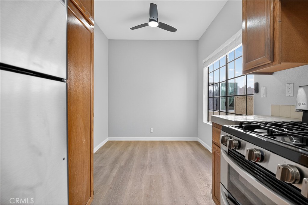 2720 Gramercy Avenue, Unit 5 Torrance, CA 90501 - Photo 16 of 35 a view of a kitchen with wooden floor stainless steel appliances and a chandelier