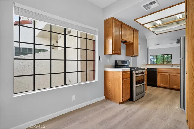 a kitchen with stainless steel appliances granite countertop a stove and a sink