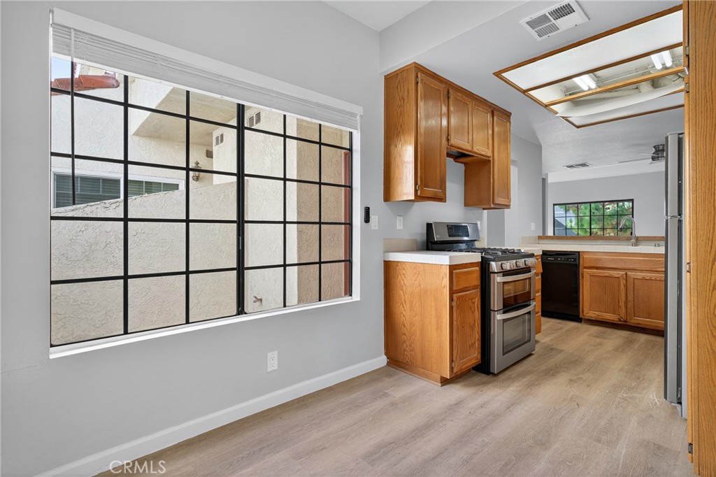 2720 Gramercy Avenue, Unit 5 Torrance, CA 90501 - Photo 17 of 35 a kitchen with stainless steel appliances granite countertop a stove a sink and a refrigerator