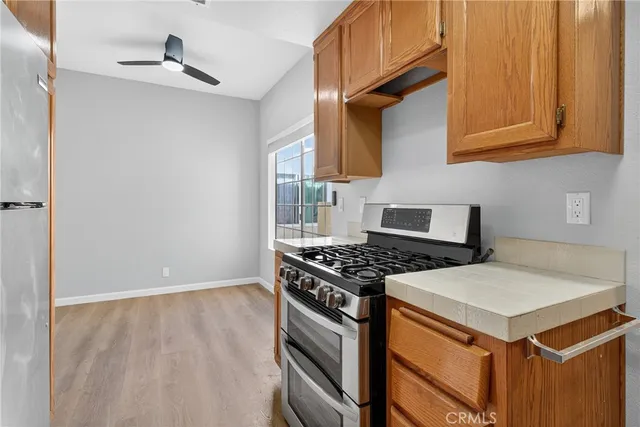 a kitchen with stainless steel appliances granite countertop a stove a refrigerator and a sink