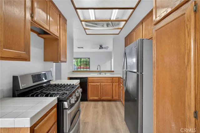 a kitchen with stainless steel appliances granite countertop a refrigerator and a stove
