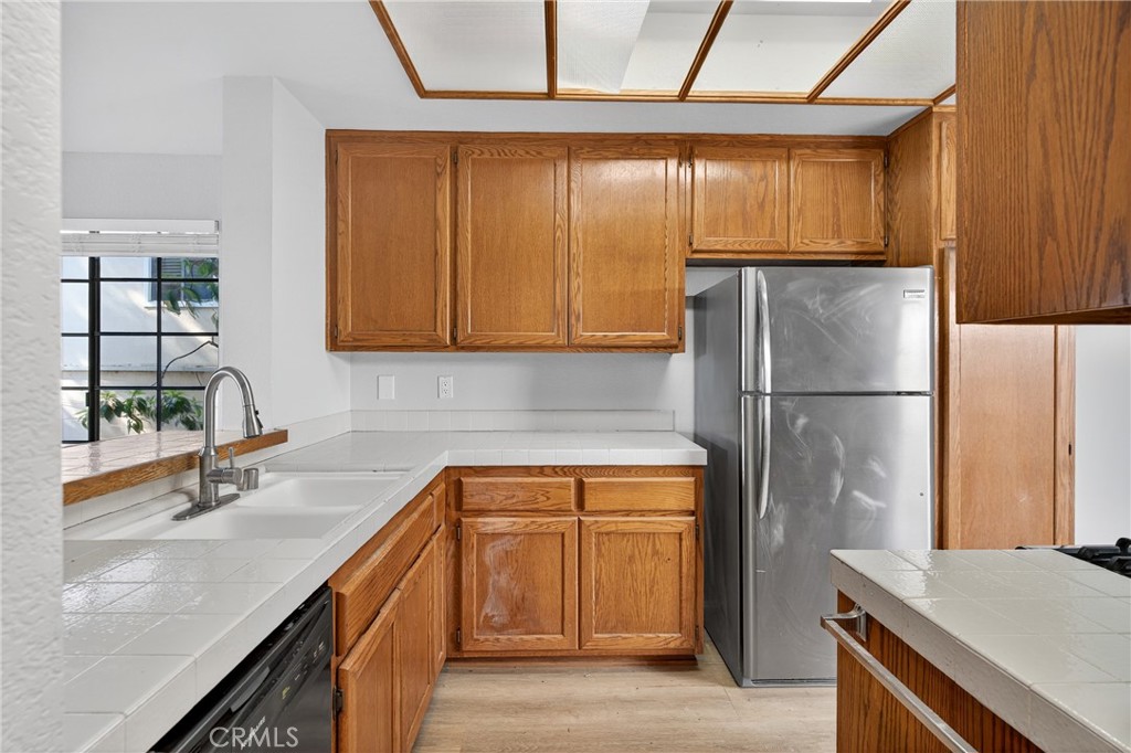 2720 Gramercy Avenue, Unit 5 Torrance, CA 90501 - Photo 21 of 35 a kitchen with stainless steel appliances granite countertop a sink and a refrigerator