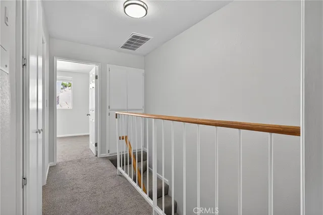 a view of a hallway with wooden floor and entryway