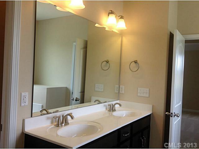78004 Rillstone Drive, Unit 181 Lancaster, SC 29720 - Photo 12 of 13 a bathroom with a sink and a mirror