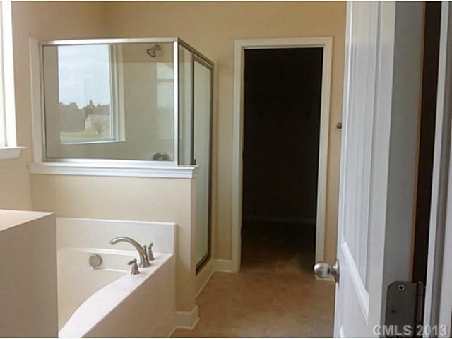 78004 Rillstone Drive, Unit 181 Lancaster, SC 29720 - Photo 13 of 13 a bathroom with a bathtub and a window