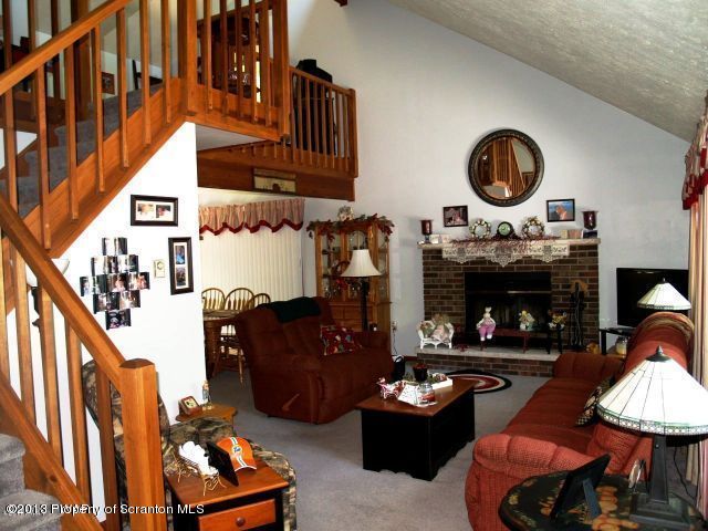 1284 Brookfield Road Lake Ariel, PA 18436 - Photo 4 of 36 a living room with furniture a fireplace and a large mirror