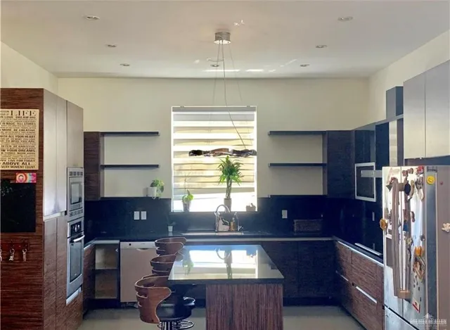 a view of a dining room with furniture and a lamp
