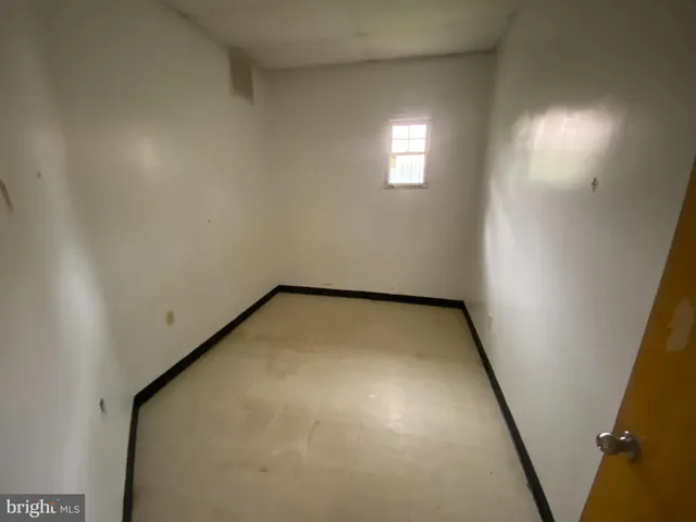 an empty room with a empty space and windows