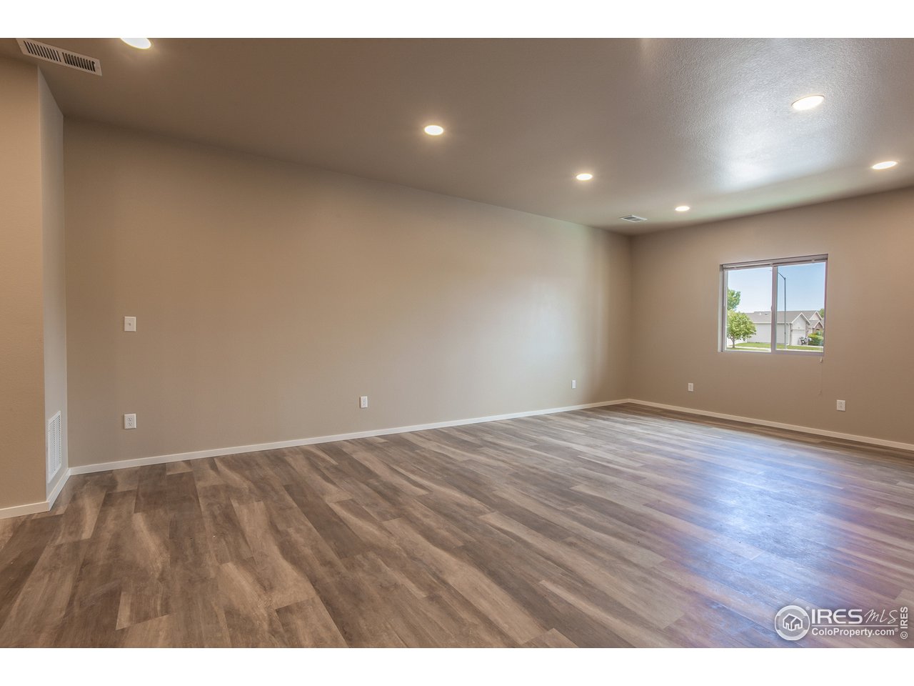 6609 4th St Road, Unit 3 Greeley, CO 80634 - Photo 28 of 28 EXAMPLE PHOTO: OPEN FLOOR PLAN W/ VINYL PLANK FLOORING