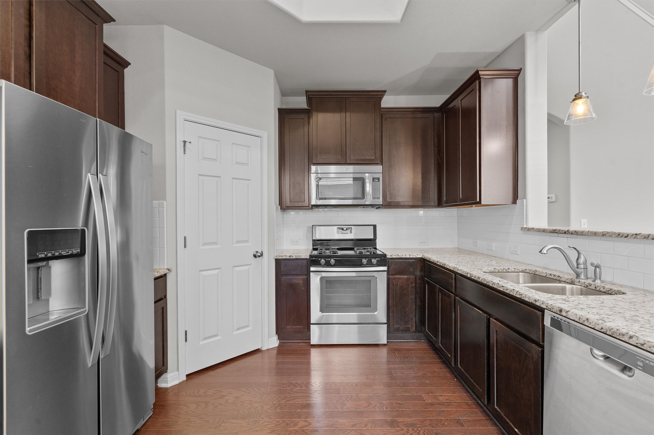 7709 Menchaca Road, Unit 22 Austin, TX 78745 - Photo 8 of 35 a kitchen with stainless steel appliances granite countertop a refrigerator stove and sink