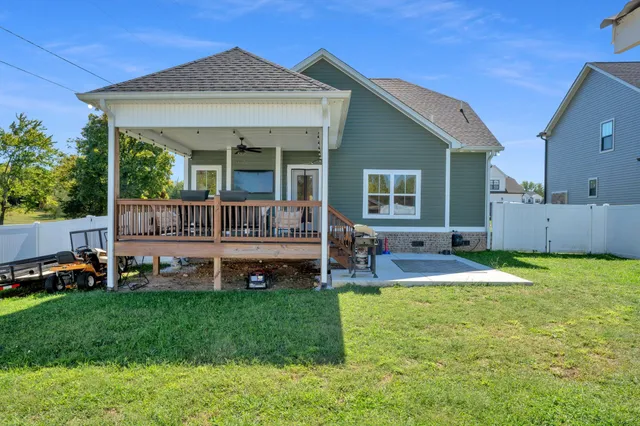 a view of a backyard with a garden and deck