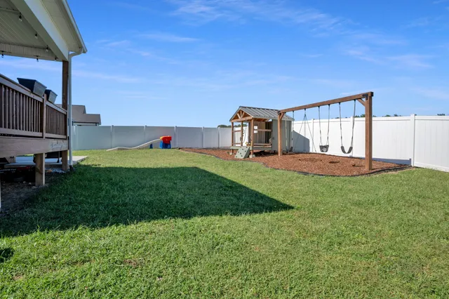 a front view of a house with a garden and yard