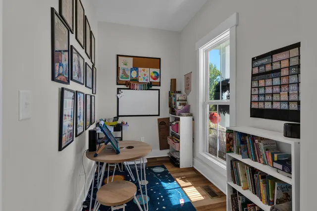 a kitchen with a sink cabinets and wooden floor