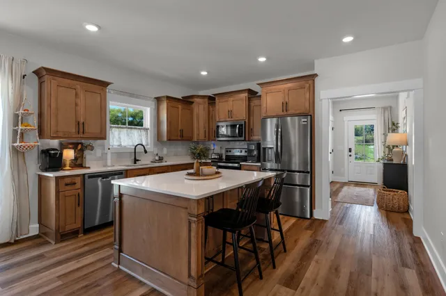 a kitchen with stainless steel appliances a sink stove and refrigerator