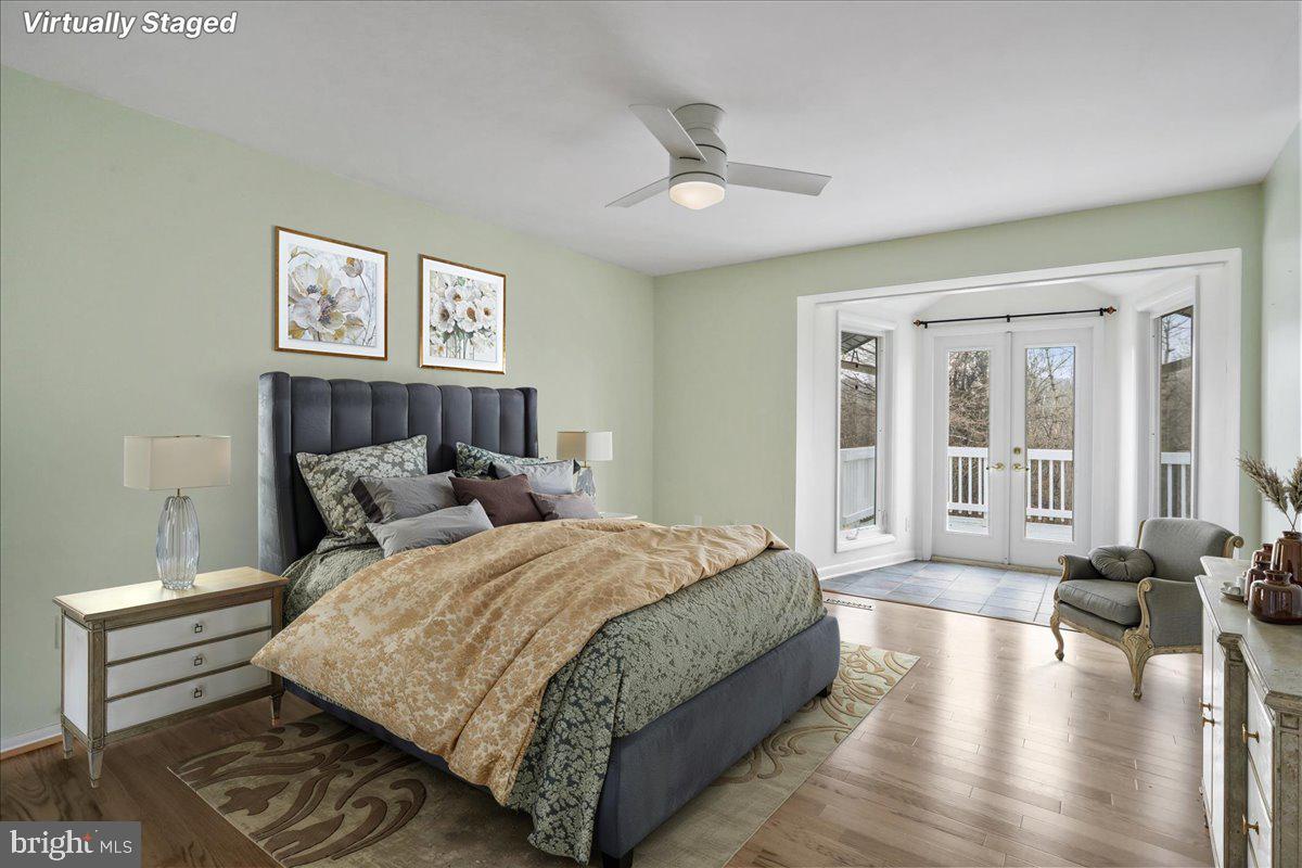 565 South River Road Front Royal, VA 22630 - Photo 30 of 68 a spacious bedroom with a bed a couch and a large window