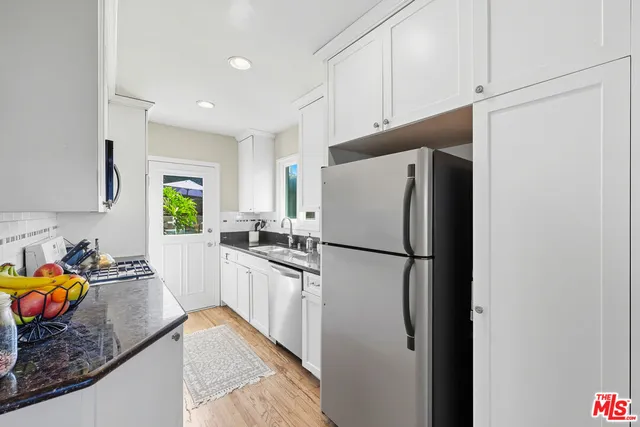 a white refrigerator freezer sitting inside of a kitchen