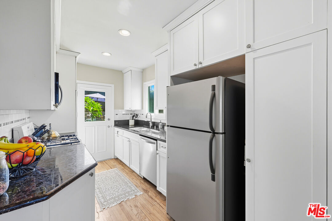 804 Hillcrest Street El Segundo, CA 90245 - Photo 11 of 34 a white refrigerator freezer sitting inside of a kitchen