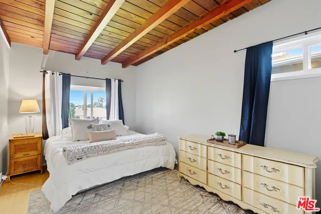 a bedroom with bed and window