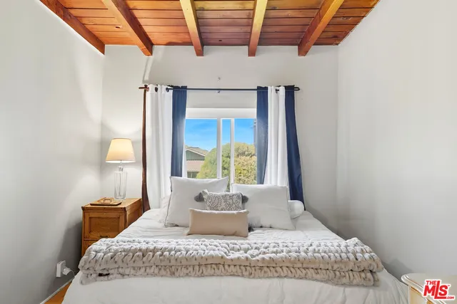 a bedroom with a large bed and a window