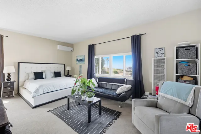 a bedroom with a bed and a couch