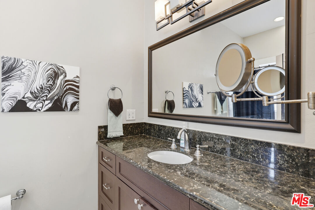 804 Hillcrest Street El Segundo, CA 90245 - Photo 23 of 34 a bathroom with a granite countertop double vanity sinks and a mirror