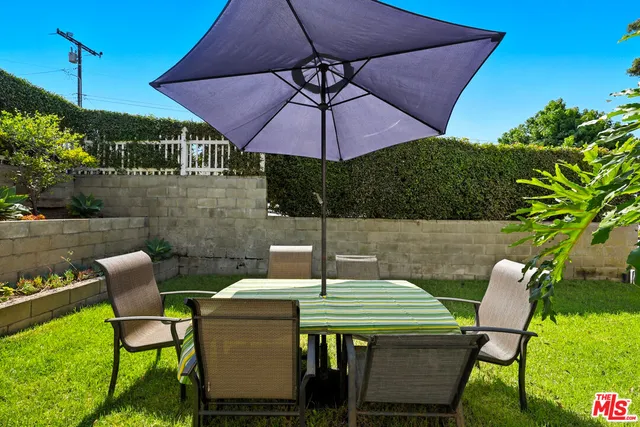 a patio with table and chairs