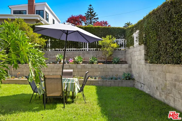 an outdoor space with furniture and umbrella