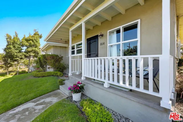 a view of a house with a yard and a garden