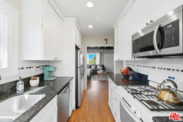 a kitchen with stove and cabinets