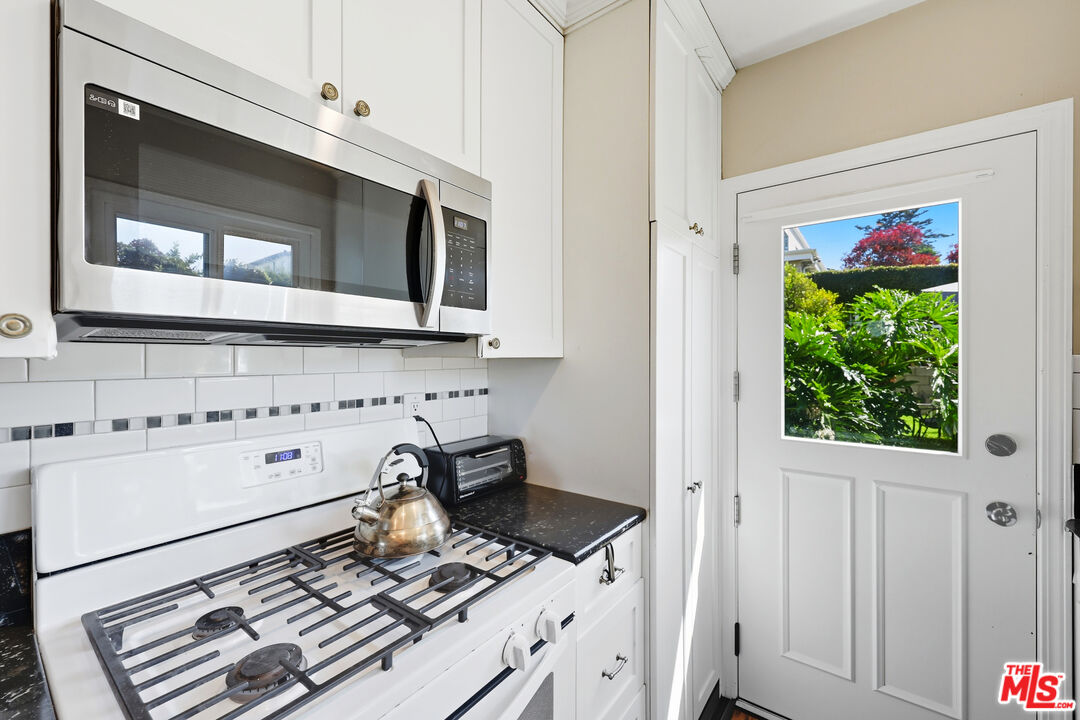 804 Hillcrest Street El Segundo, CA 90245 - Photo 10 of 34 a kitchen with stainless steel appliances granite countertop a stove and a microwave