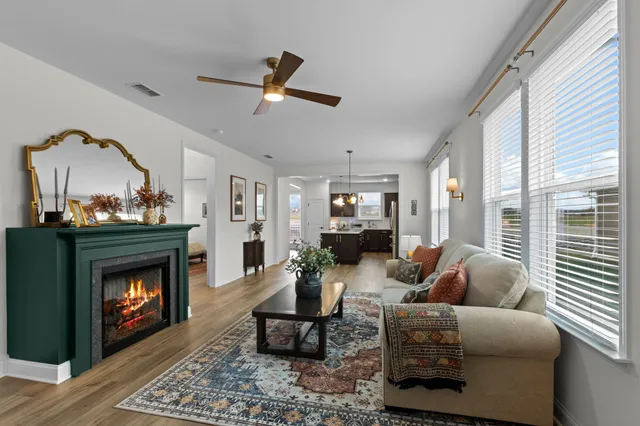 a living room with furniture a window and a fireplace