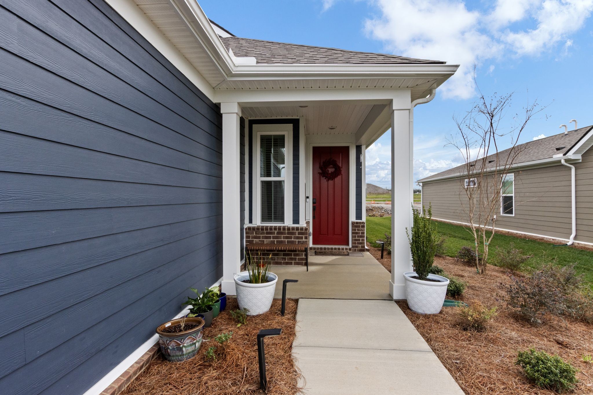 7153 Triad Way Murfreesboro, TN 37128 - Photo 6 of 35 a front view of a house with garden