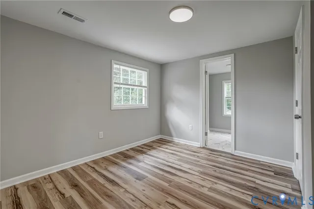 a view of room with window and hardwood floor