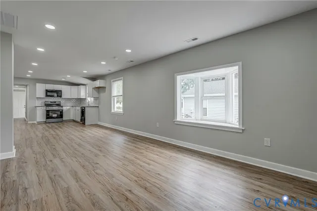 a view of kitchen with furniture and wooden floor