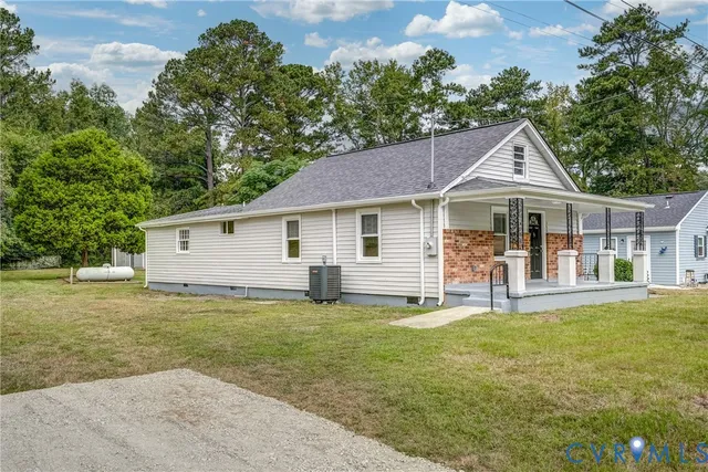 a front view of a house with a yard table and chairs