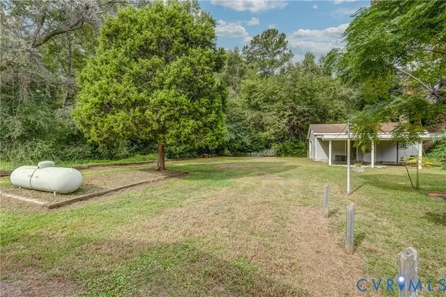 a view of a house with backyard porch and garden