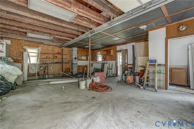 a view of a room with wooden floor and furniture