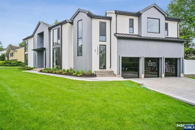 a view of a house with a yard and pathway