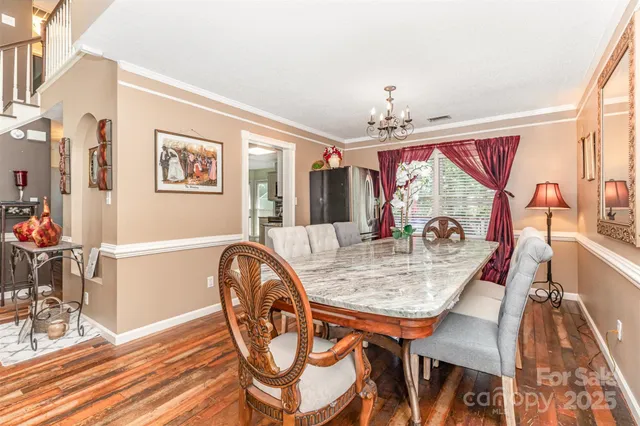 a dining room with furniture and wooden floor