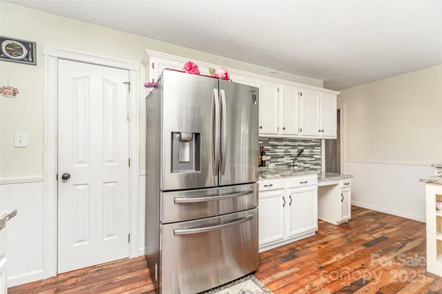 a kitchen with stainless steel appliances a refrigerator and a stove top oven