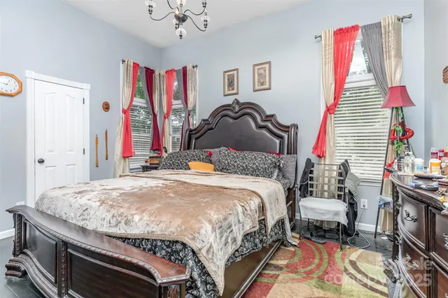 a bedroom with bed and a book shelf